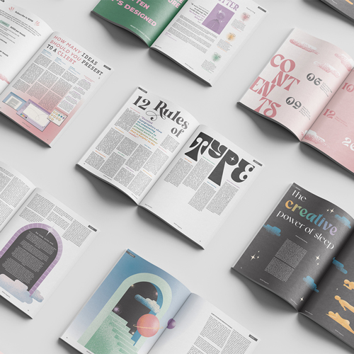 Top-down view of several open magazines spread on a light surface, showcasing colorful typography and design layouts.