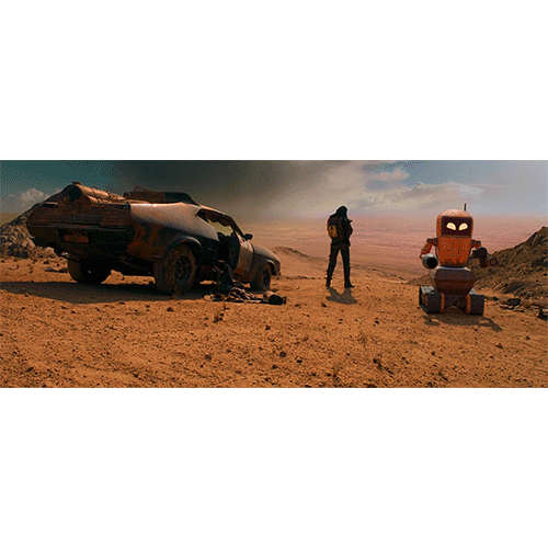 Desert landscape with a toppled car, a person standing in the middle, and an orange robot on the right.