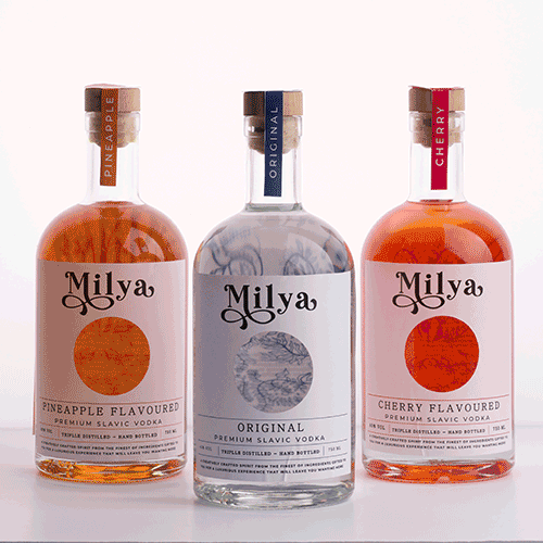 Three Milaya vodka bottles in pineapple, original, and cherry flavors on a white background.