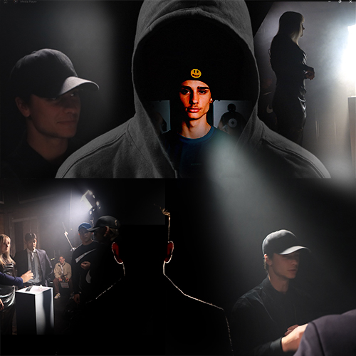 Hooded figure with a glowing symbol on the forehead surrounded by film crew in a dim studio set.